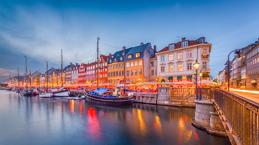 Copenhagen, Denmark skyline on the Nyhavn Canal at twilight.